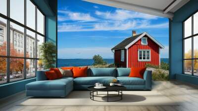 Red wooden house or cottage near the sea in Sweden on a sunny summer day Wall mural