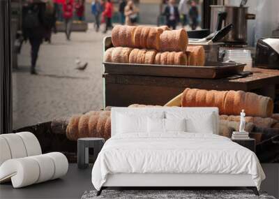 Trdelnik - traditional Czech hot sweet pastry baked on a stick and sold in the streets of Prague Wall mural