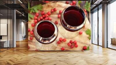 Two glass cups of medicinal wine prepared from fresh hawthorn berries Wall mural