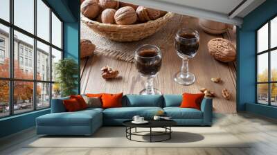 Two glasses of homemade nut liqueur with walnuts Wall mural