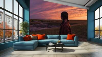 woman looking out at badlands sunset Wall mural