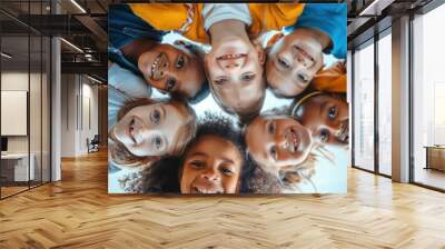 A diverse group of children playing together in a park, smiling and laughing Wall mural