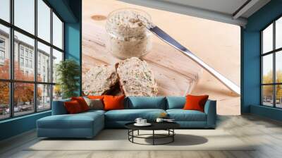 Savor the richness of sliced brown bread with delectable spread against rustic wooden background Wall mural