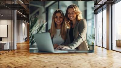 Two Smiling Female Working Partners Working Together on Laptop in office, Teamwork, Young Businesswomen, Co Workers, Team building Concept Wall mural