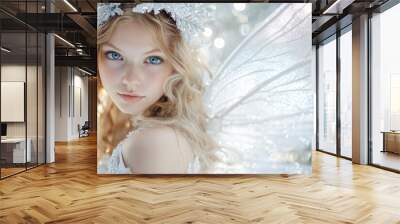 A young woman dressed as a Christmas fairy, with wavy blonde hair and enchanting blue eyes, on a sparkling silver background, bringing holiday enchantment 1 Wall mural