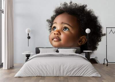 African baby girl with curly hair and dark skin, sitting on a white background 2 Wall mural