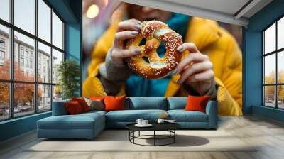 Detailed close-up of a woman munching on a crispy, salty pretzel Wall mural