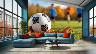 A group of soccer players engaging in practice drills on a grassy field surrounded by the vibrant colors of autumn leaves on a sunny day Wall mural