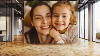 Mother and daughter smiling together, enjoying family time at home Wall mural