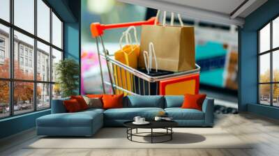 Online Shopping Concept with Miniature Cart, Shopping Bags, and Laptop Displaying E-commerce Website Wall mural