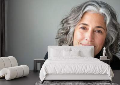 Smiling mature woman with gray hair in a natural setting Wall mural