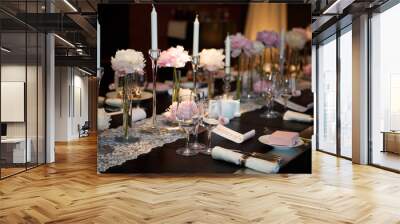 Cutlery table covered in natural crocodile skin. Glasses and plates, forks and knives, napkins and buttons for a luxurious celebration in anticipation of guests. Luxury festive table.  Wall mural