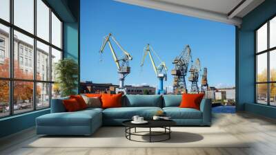 Loading cranes at the sea port. Cargo transportation by ships. Wall mural