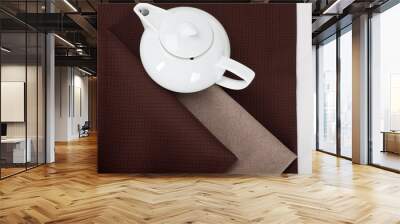 top view of a white teapot on a brown linen tablecloth  Wall mural