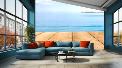 A wooden table on a beautiful sunny holiday day with a charming sea landscape  Wall mural