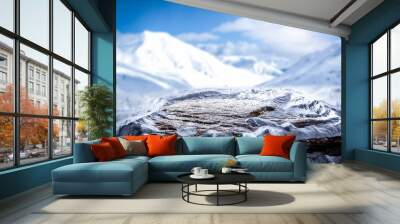 An empty stone with a free space against the background of a winter landscape of snowy mountains Wall mural