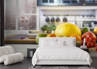 Fresh fruit in the kitchen on a wooden table by the sunny window Wall mural