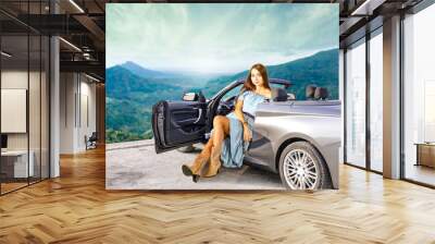 slim young woman in summer car.  Wall mural