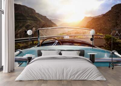 Summer car on road and sunset time in mountains.  Wall mural