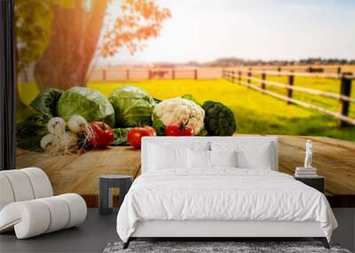 Table background with fresh vegetables and sunny autumn view.  Wall mural