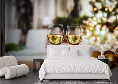 Two glasses with white wine on an old wooden table in a Christmas mood   Wall mural