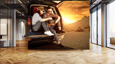 Two young people and autumn trip of car  Wall mural