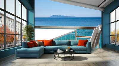 White table with chairs on the beautiful ocean view. Wall mural