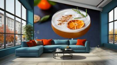 Christmas cocktail of amaretto sour with dehydrated clementine and rosemary Wall mural