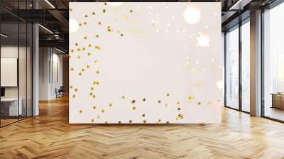 Festive gold background. Shining stars confetti and fairy lights on beige and Set Sail Shampagne background. Christmas. Wedding. Birthday. Flat lay, top view, copy space Wall mural