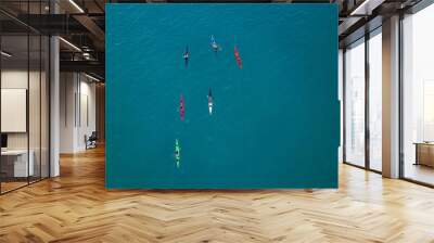 Aerial image of kayakers paddling forwards. Sport canoes and Kayaks at sea. Wall mural