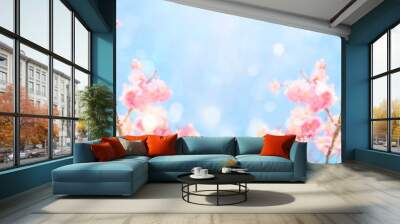 Beautiful cherry blossom flowers over blurred background. Spring season concept Wall mural