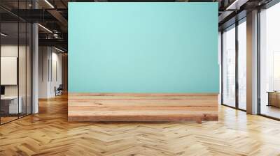 Empty wooden deck table over mint wallpaper background Wall mural