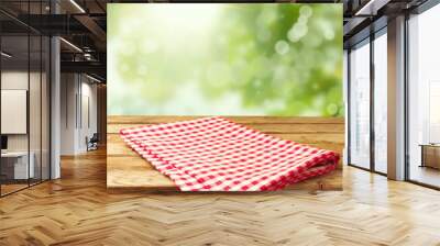 Empty wooden deck table with tablecloth over bokeh background Wall mural