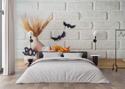 Halloween background with modern vase and decoration on wooden table over brick wall. Empty space for product display Wall mural