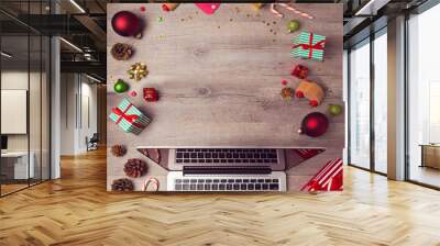 Laptop computer with Christmas decorations on wooden background. Christmas mock up template. View from above Wall mural