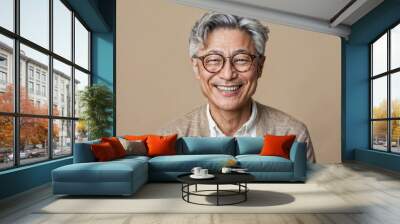 Studio portrait of a happy Japanese mature man looking at camera with relaxed happy expression and toothy smile. The man has around 50 years and has grey hair. Wall mural