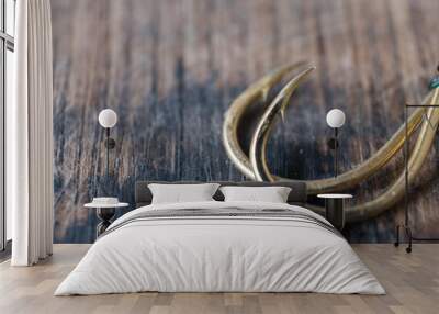 Fishing hooks close up on a wooden background. Wall mural