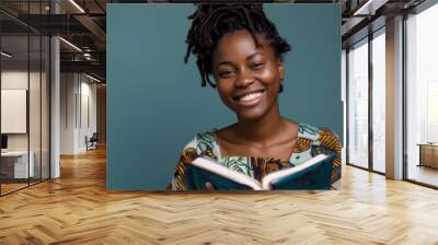 african Pretty woman smiling Holding a book open in hands blue background png file Wall mural