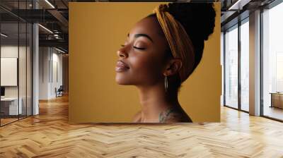 A close up of a tattooed black woman's face with her eyes closed Wall mural