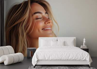 A close up of a woman's face with her eyes closed and long blond hair Wall mural