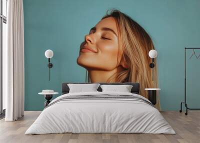 A close up of a woman's face with her eyes closed and long blond hair Wall mural