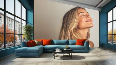 A close up of a woman's face with her eyes closed and long blond hair Wall mural