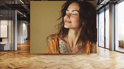 A close up of a woman's face with tattoos and her eyes closed Wall mural