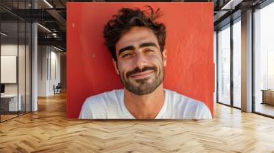 A close up portrait of a young man with a subtle smile Wall mural