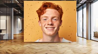 A young man with red hair and freckles smiles for the camera Wall mural