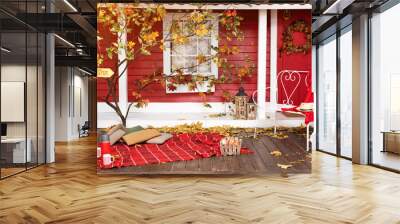 Autumn picnic on the terrace. Red plaid, basket with apples and thermos with hot drink. Veranda of countryside house in autumn season. Wall mural