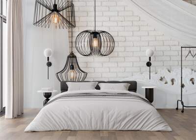 Black lamps in light bedroom interior. Three modern black lamps hanging Wall mural