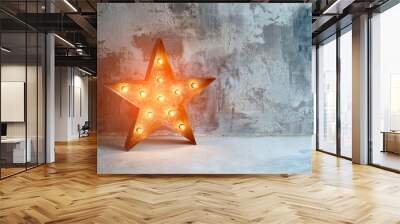 Large decorative retro star with lots of burning lights on grunge concrete background. Beautiful decor, modern design element. The loft style studio. Free space for text Wall mural