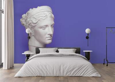 Marble head of young woman, ancient Greek goddess bust isolated on violet background, very peri color of 2022 year Wall mural