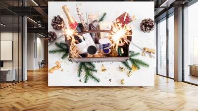 Sparklers and wooden basket with food for Christmas selebration. Happy winter holidays. Presents for Christmastime. Wall mural